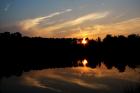 sun sets on pond
